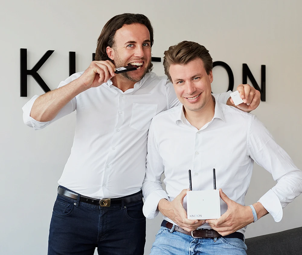 The founders Oliver and Alex holding KINEXONs IoT devices for RTLS systems. 