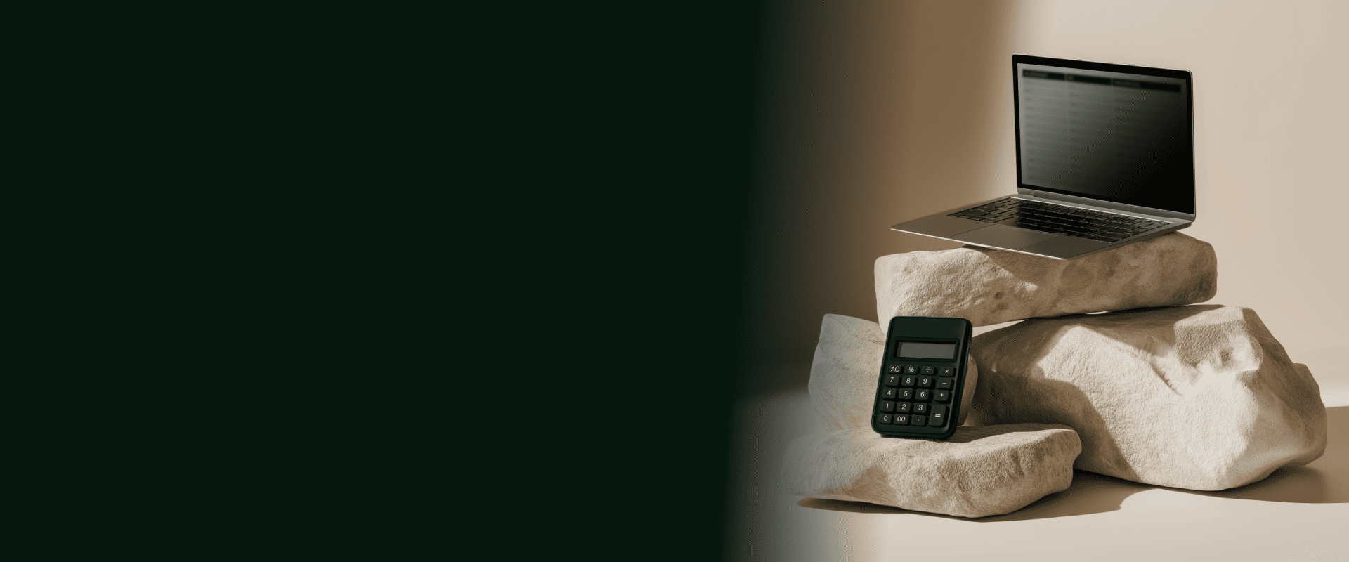 A laptop and a calculator balanced on rocks to represent GL accounts in financial reporting.