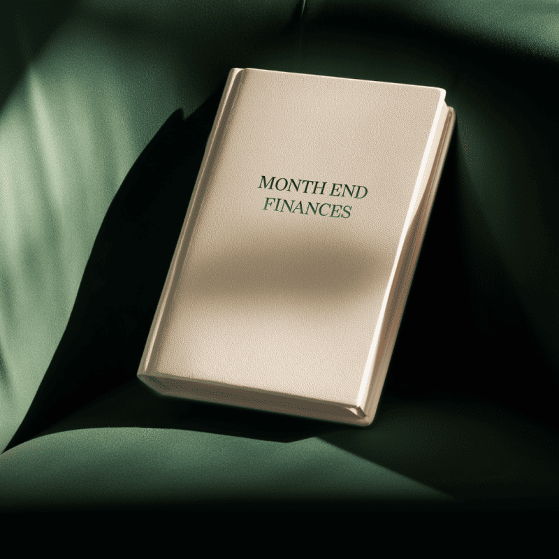 A leather journal with the title "Month End Finances" that's meant to represent the month end close process. 