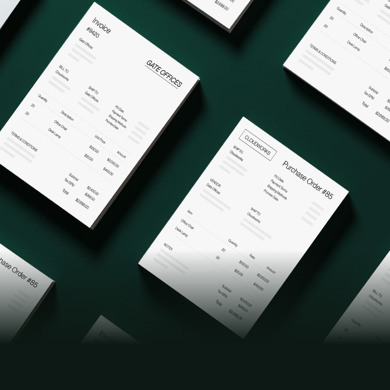 Purchase orders and invoices laid flat on a dark green table. 