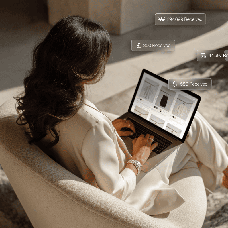 A view of a woman from behind as she's sitting in a chair managing her business and exploring global expansion options.