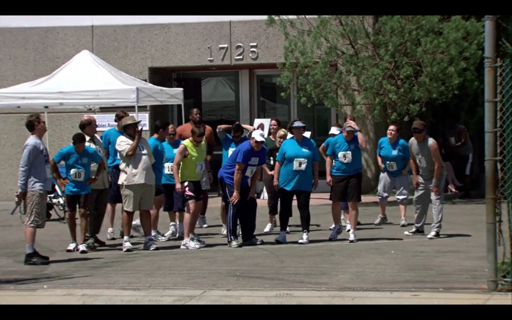 An image from The Office episode where they organized a charity run for raising donations and awareness to rabies.