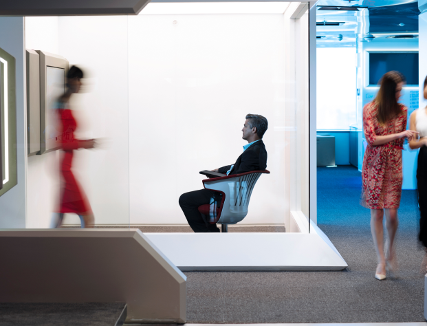 man and woman engage in conversation within a professional office setting.