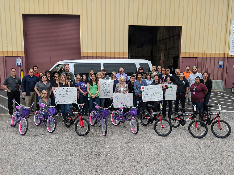 Group with donated bicycles after a FullTilt Bike Build charity event
