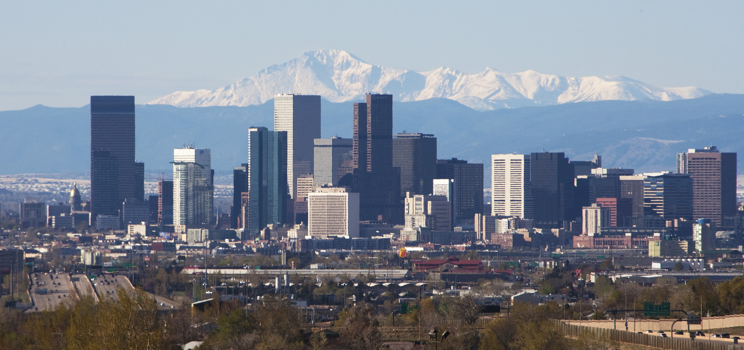 Denver skyline with the Rocky Mountains behind it