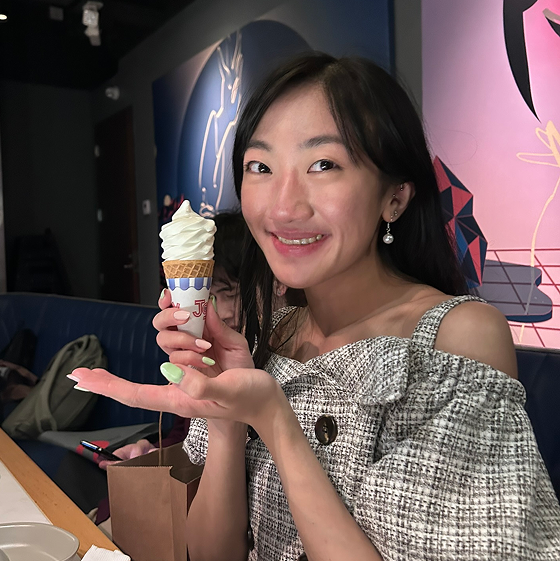 Jay holding a soft serve with a slight smile