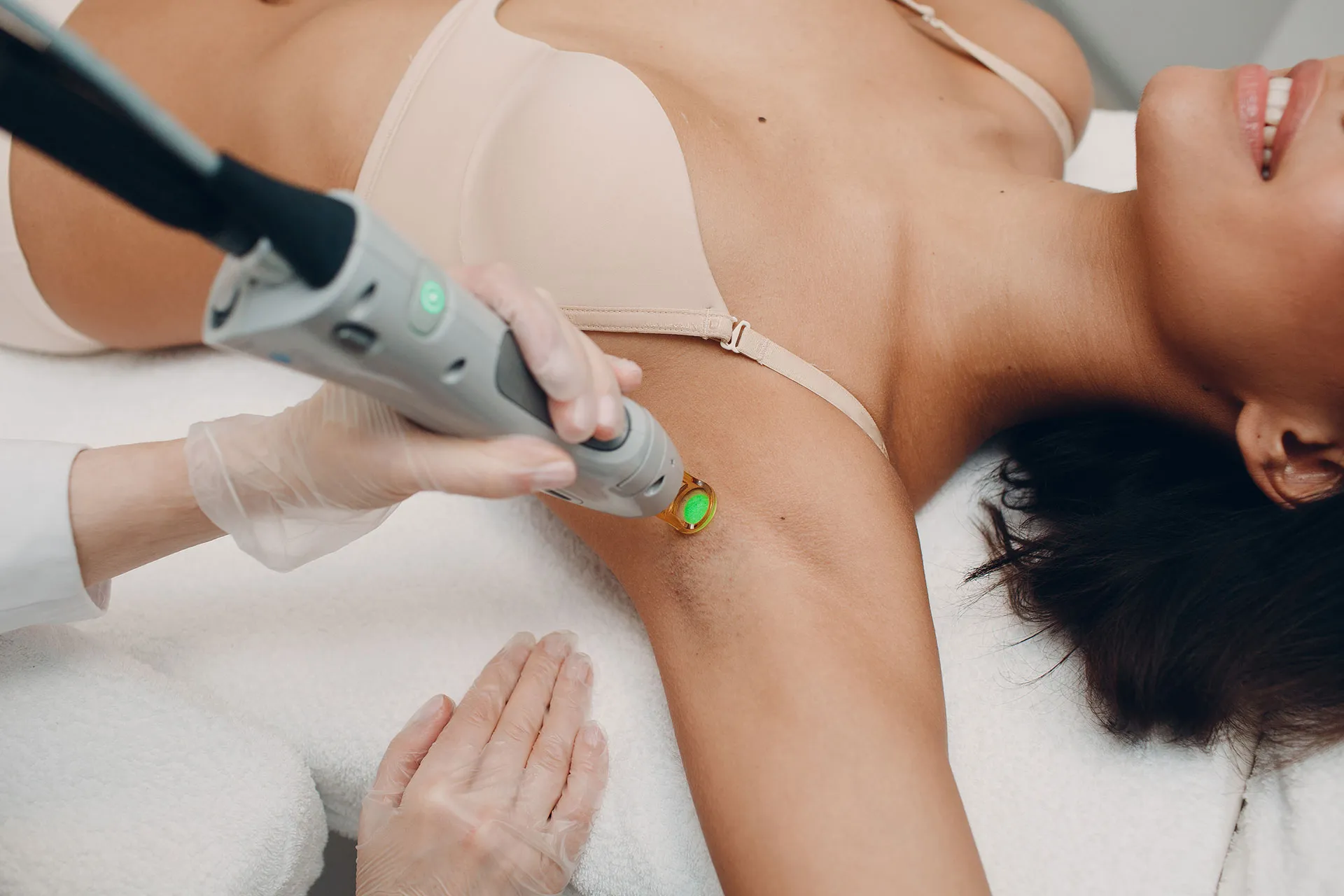 a woman in a bra getting laser hair removal