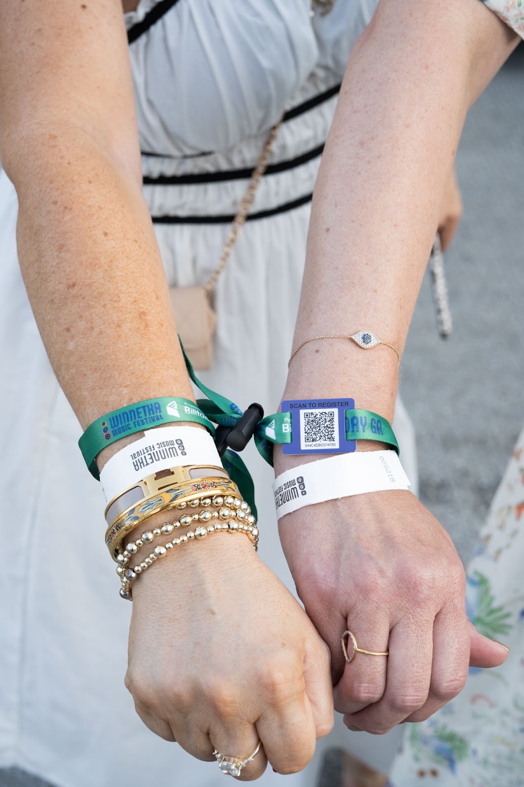 Close-up of RFID wristbands for events showing festival attendee wearing multiple event access bands