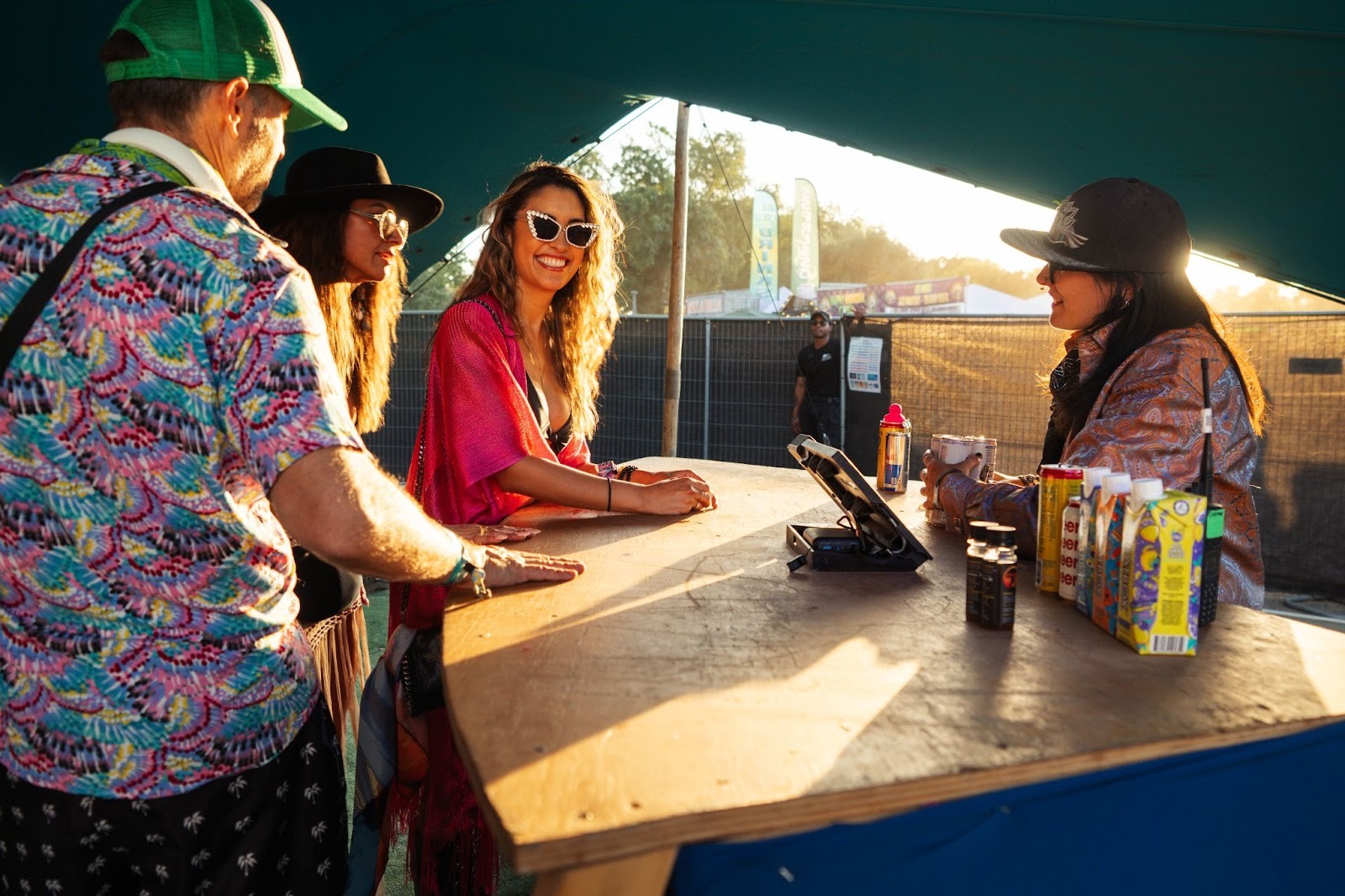 Festival attendee enjoying seamless payment experience at waterfront bar using RFID technology