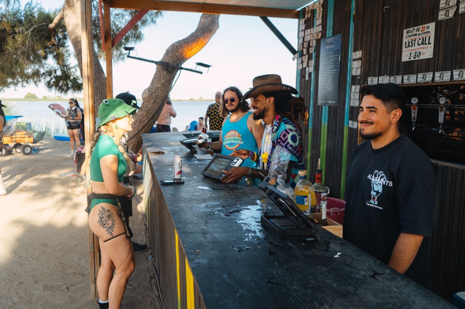 Event attendee using contactless POS payment system at busy festival bar