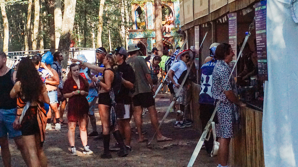 Festival attendees purchasing food and drinks at an outdoor event