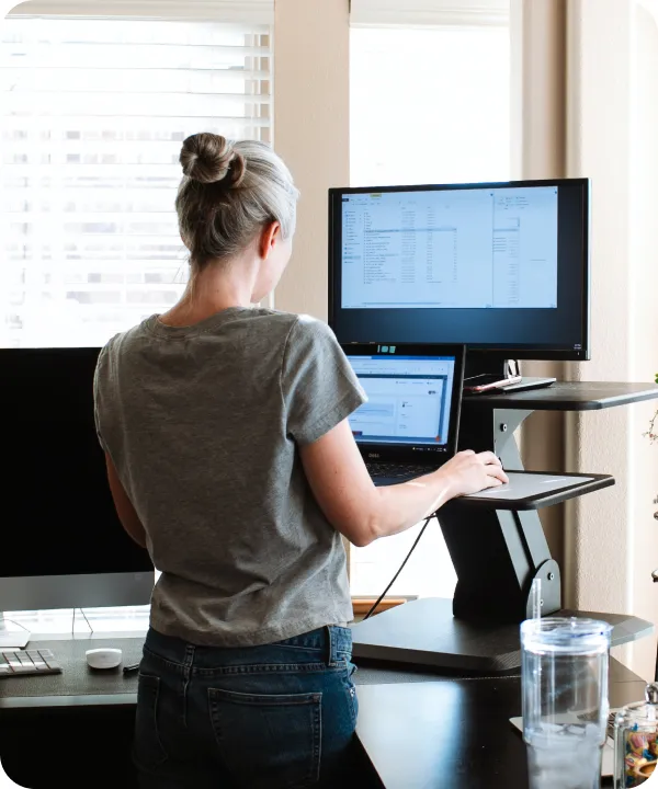 Woman looking at laptop screens