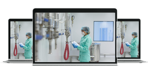 Medical professional in protective clothing and mask working with infusion pump equipment in a clean clinical environment.