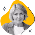 Portrait of a smiling older woman with short blond hair on a yellow abstract background.