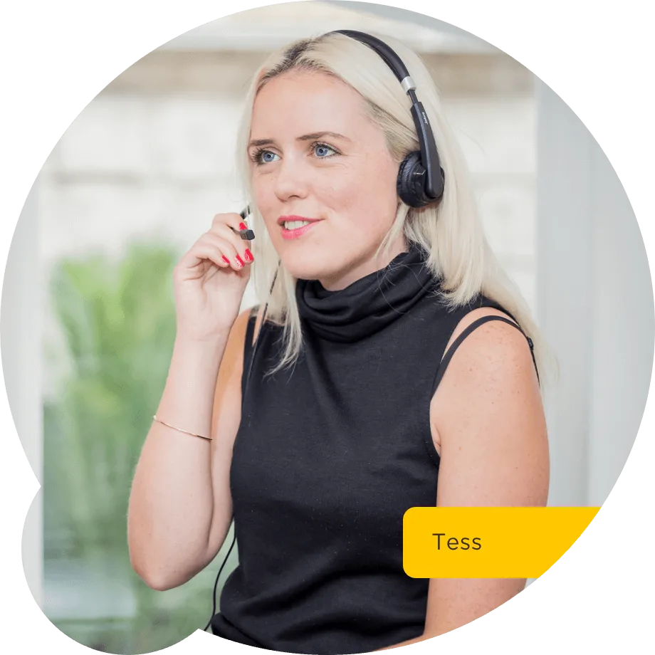 Blonde woman named Tess wearing a black sleeveless top and headset, speaking in a bright office setting.