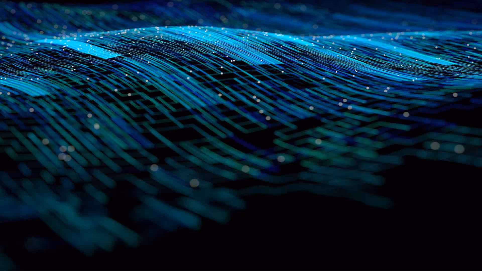 A close-up of a computer circuit board illuminated by blue lights, showcasing intricate electronic components.