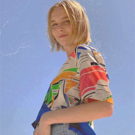 A woman with blond hair and a colorful shirt