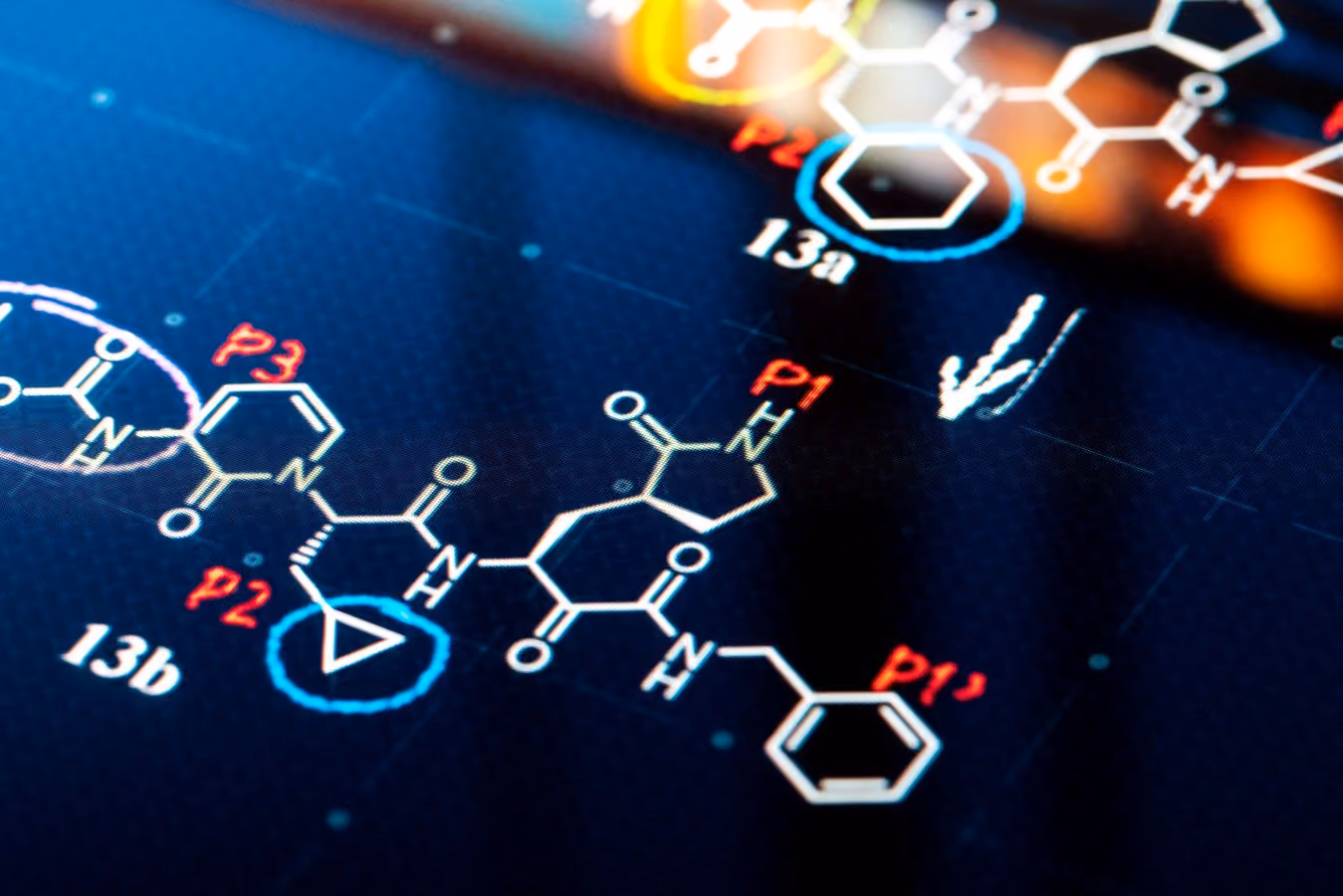 Close-up of a digital chemical structure diagram with labeled molecular components on a blue background.