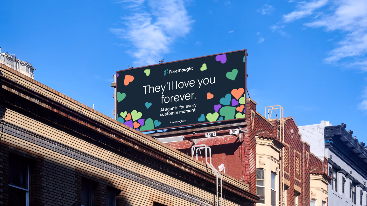 A billboard advertisement hung up in a busy city roofline.