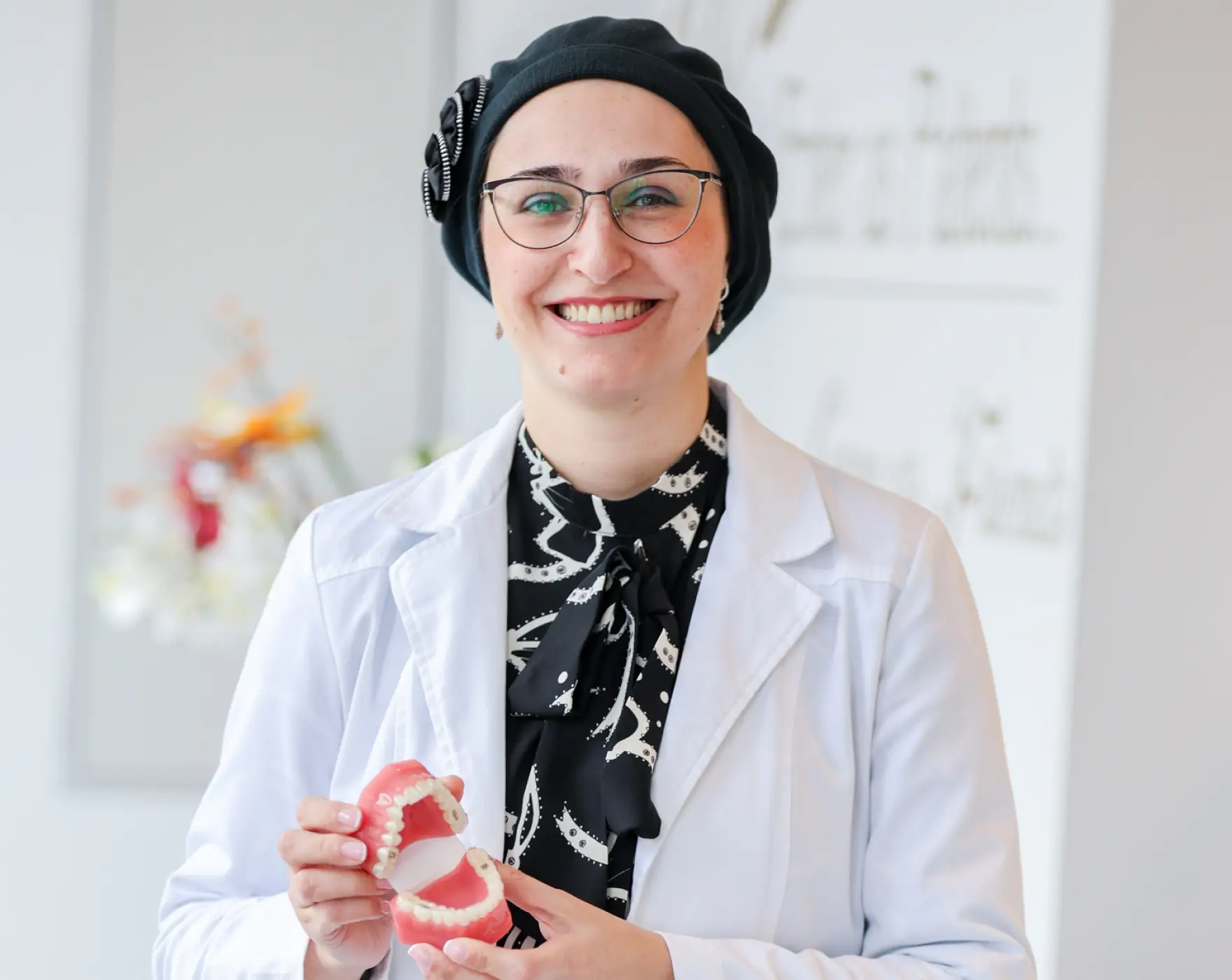 Dr. Mariya Dayanayeva holding a denture