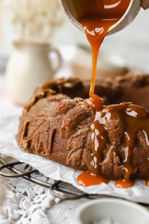 Chai Bundt cake with caramel sauce being poured over the top