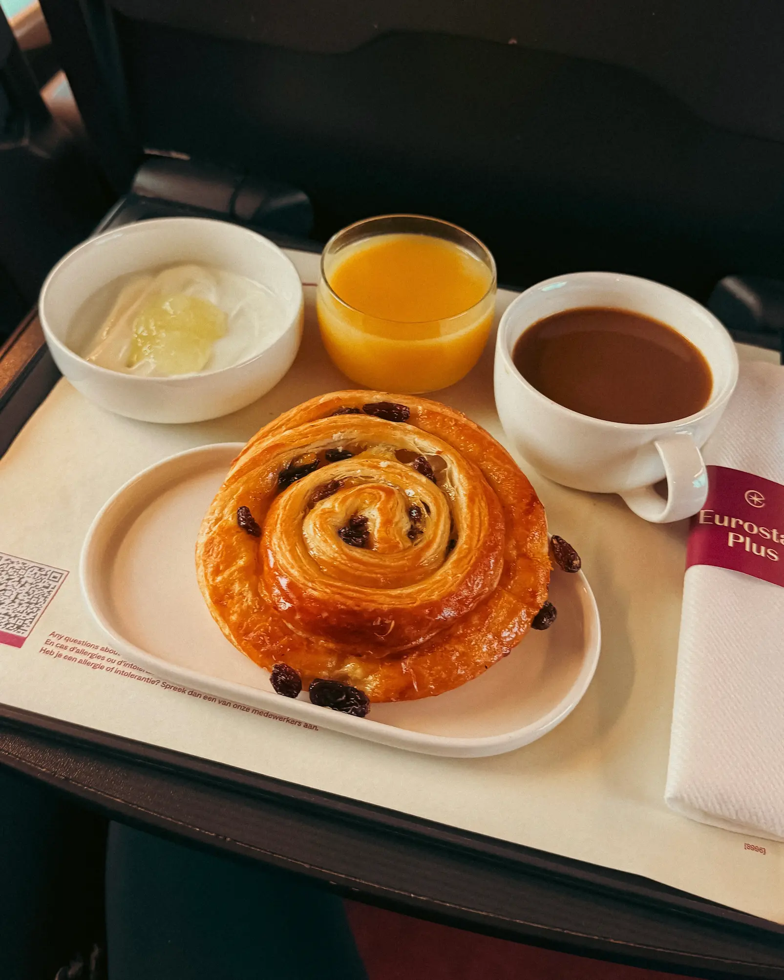 Eurostar Plus breakfast tray with pastry pain au raisin swirl, yoghurt, orange juice and coffee served onboard the London to Paris train.