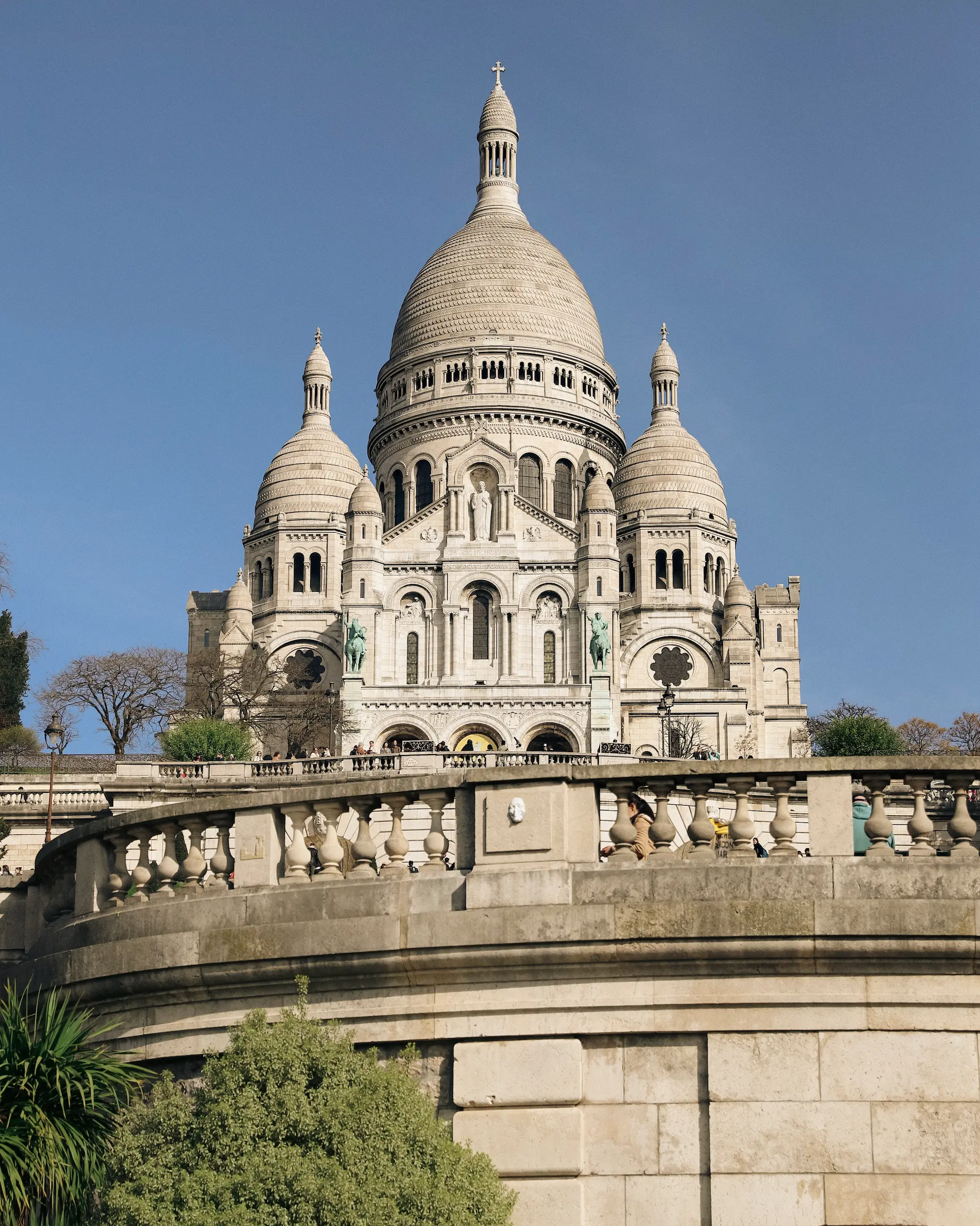 Sacré-Cœur Basilica in Montmartre Paris under blue skies on a sunny spring morning.