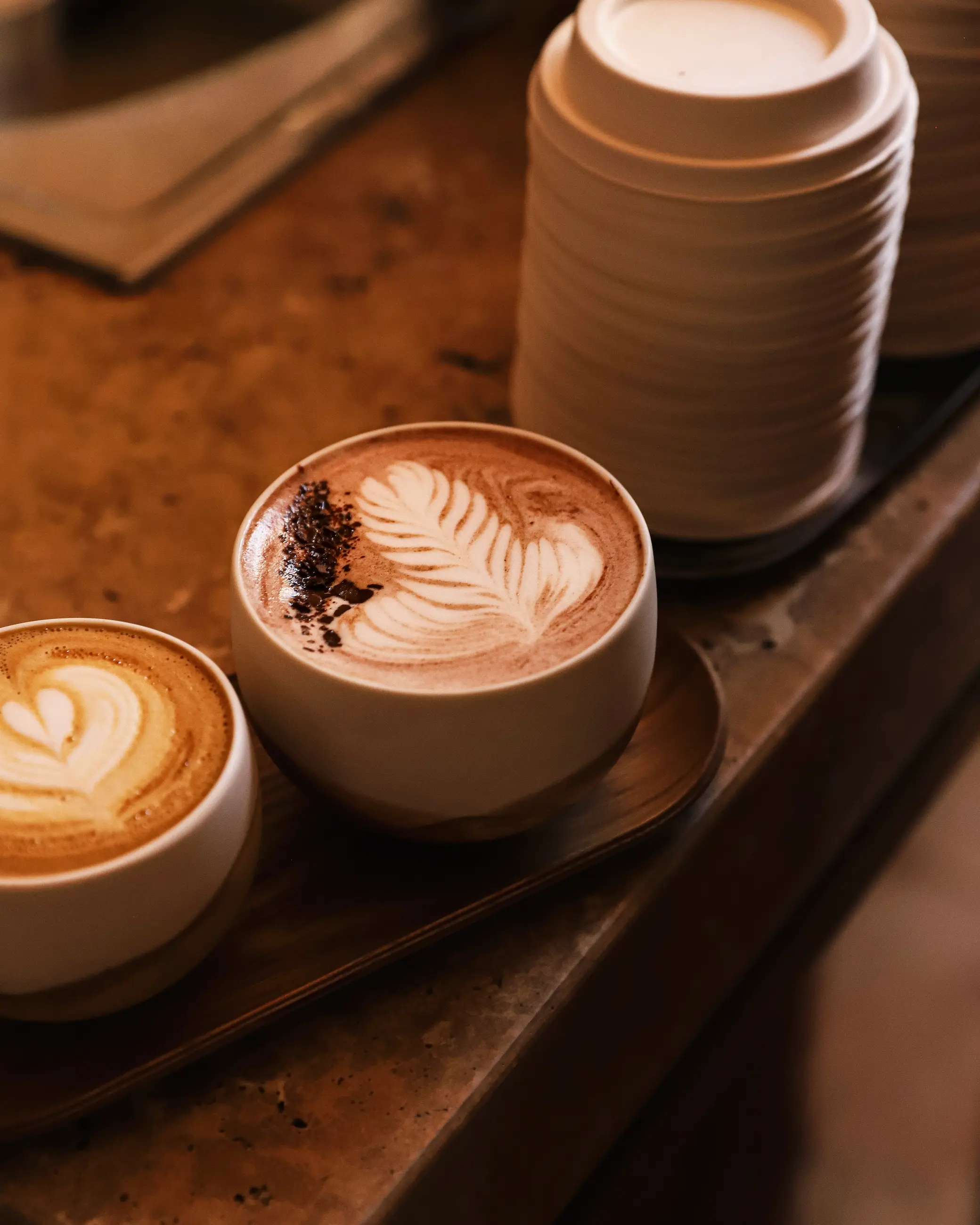Coffee and hot chocolate with latte art served at Café Noir in Paris, a cosy speciality coffee shop in the 9th arrondissement.