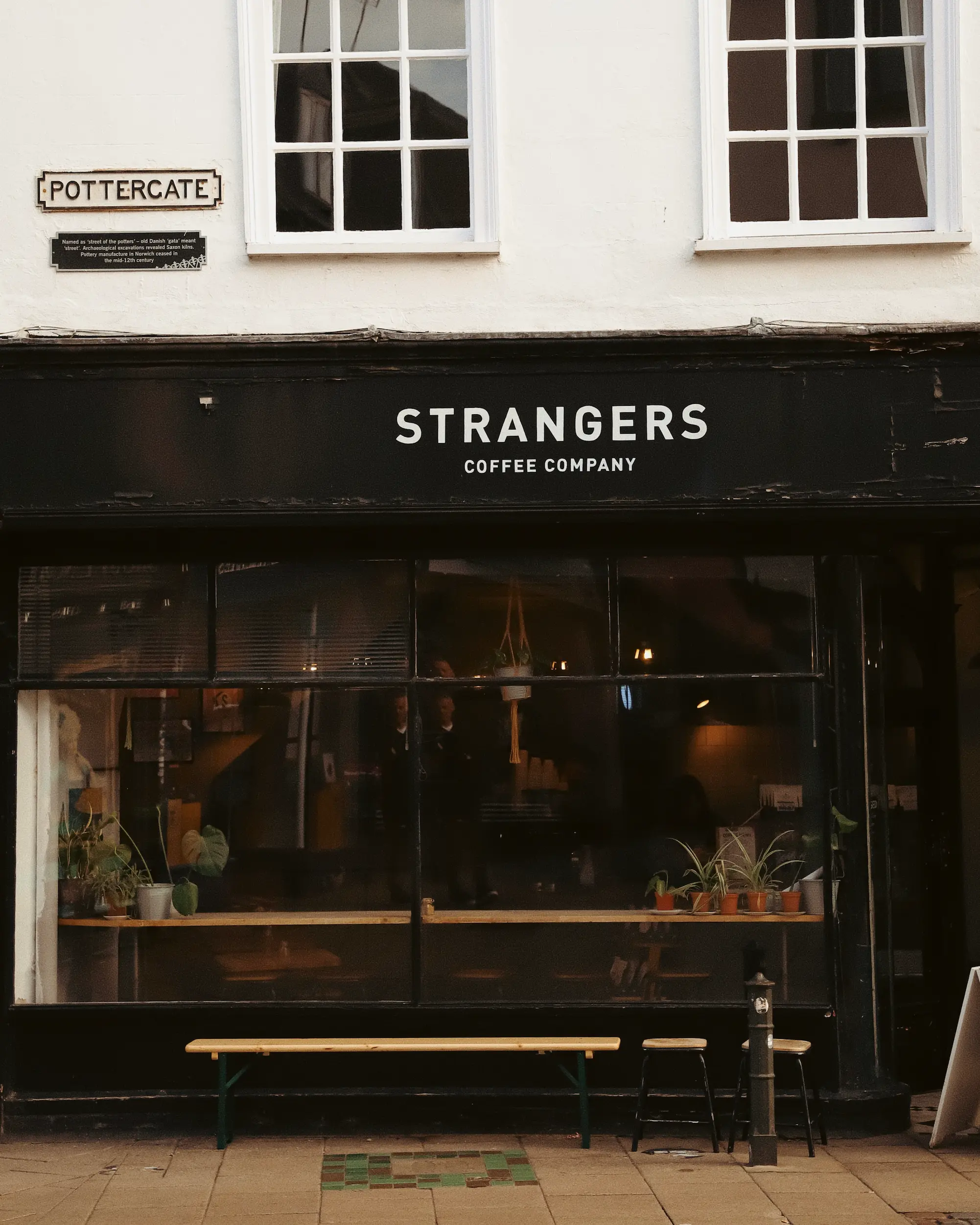 Strangers Coffee Company storefront on Pottergate in Norwich with black exterior and window seating.