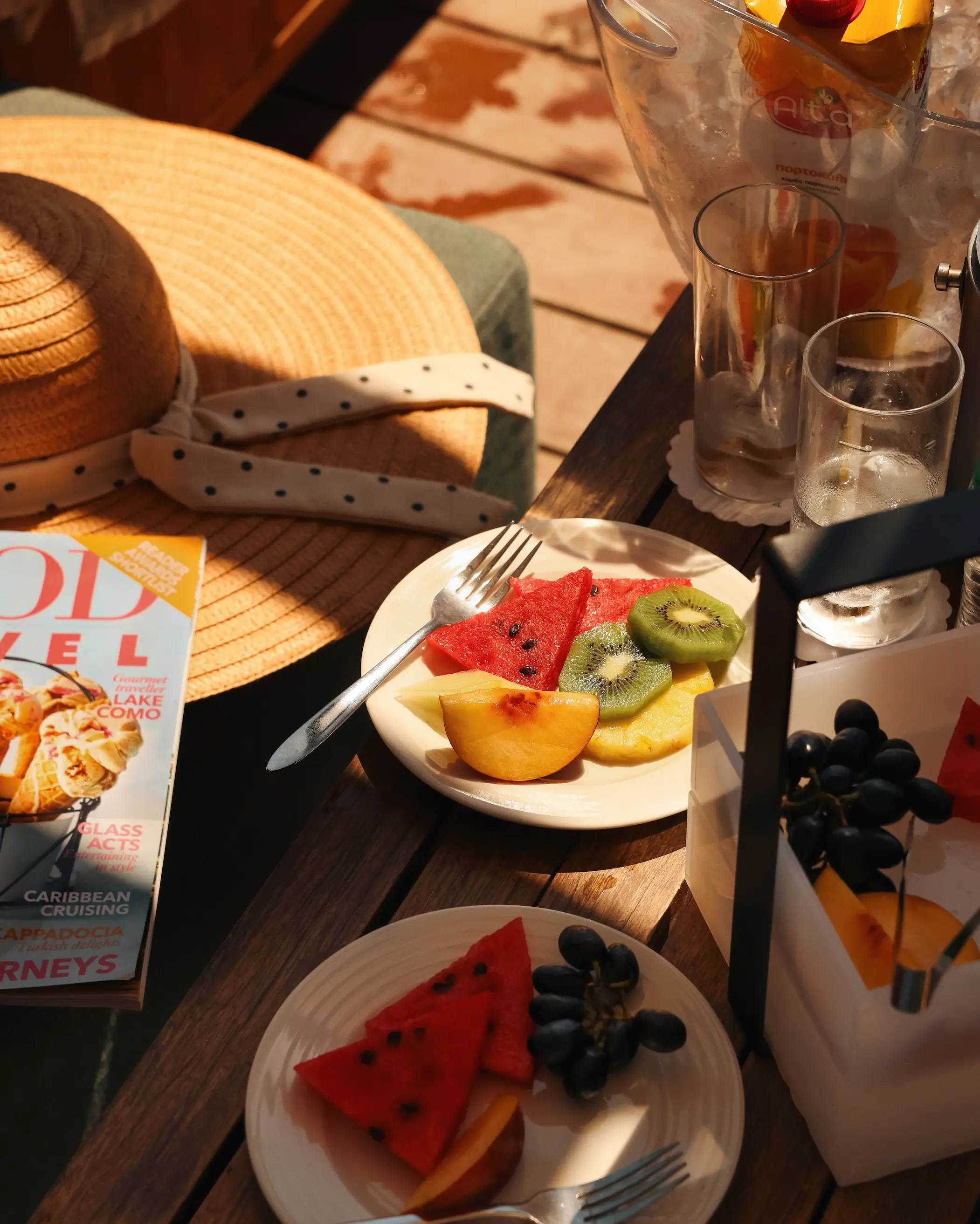 Fresh fruit, cold drinks and a magazine laid out inside a private beach gazebo at Amada Colossos Resort in Rhodes.