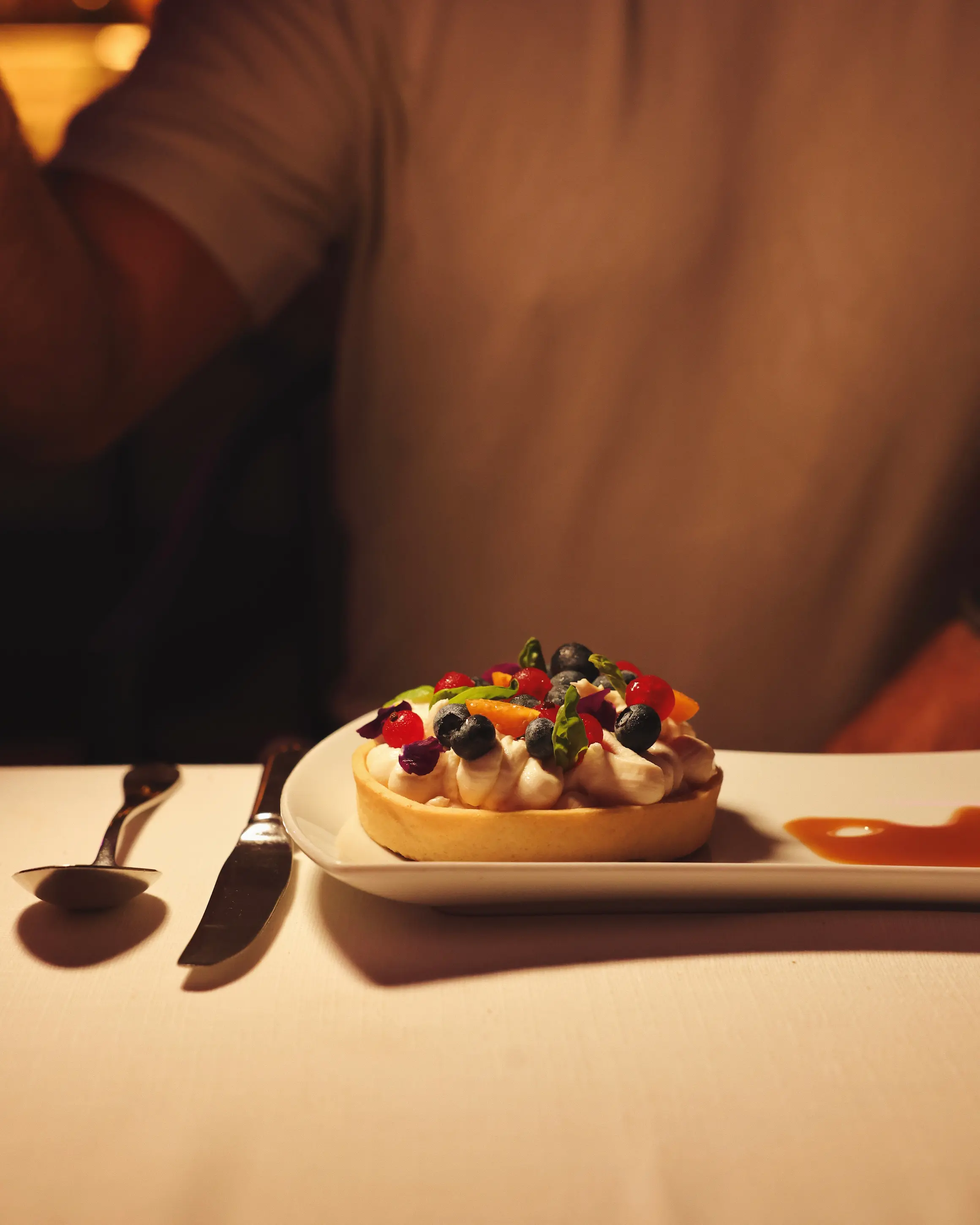 Fruit tart topped with berries, citrus and cream served for dessert at Rodos Park in Rhodes.