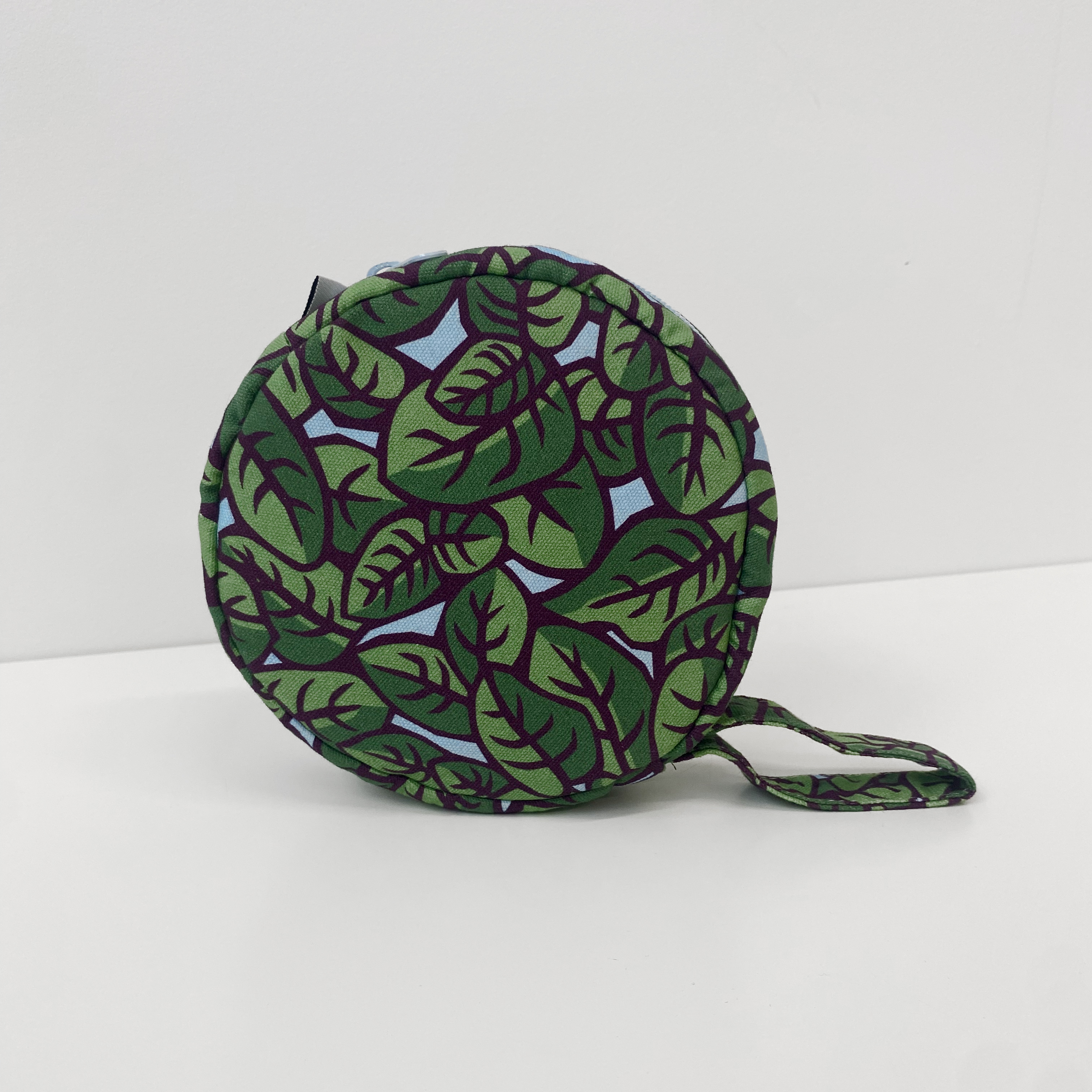 A square pillow with light blue and white stripes.