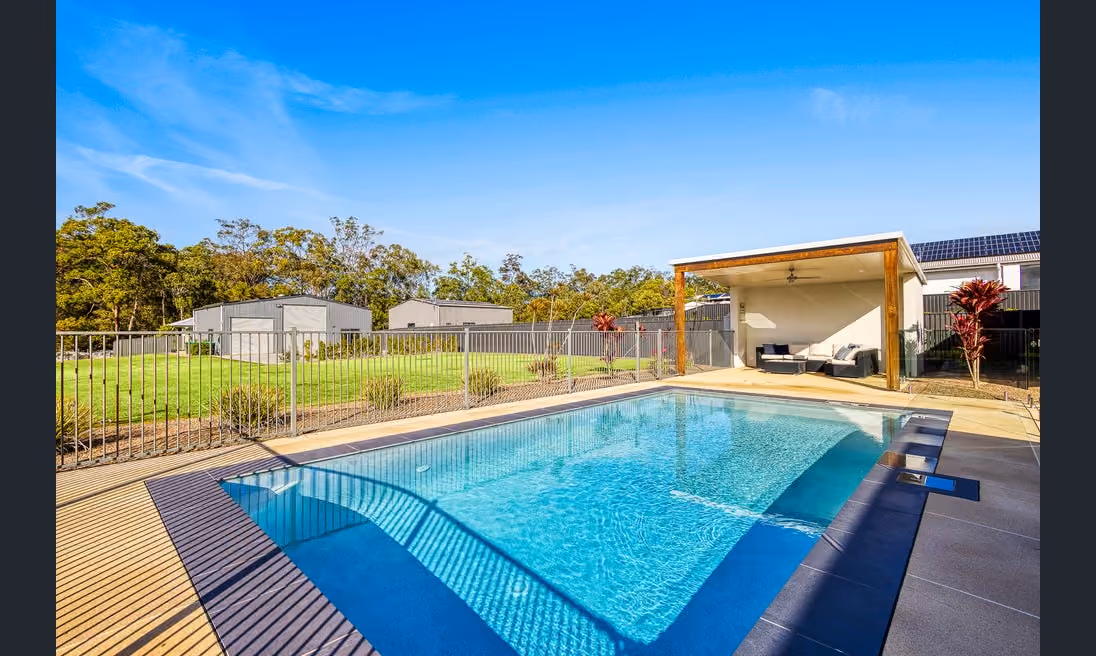 Noble Estate Agents proudly present 40 Glassing Avenue, Palmview Forest, a remarkable property exuding casual elegance on a premium acre of land with a serene treed outlook. 