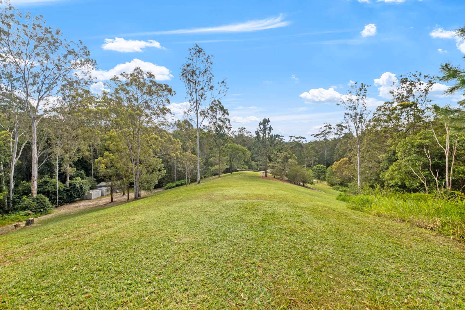 Welcome to this exceptionally private and peaceful acreage residence, offering everything you could wish for in a tranquil retreat. Spanning across 19 acres in a secluded valley, this property features a near-new 3-bedroom, 2-bathroom home, a charming 1-bedroom, 1-bathroom cabin currently listed on Airbnb, multiple sheds, a fenced horse paddock, dams for recreational activities and irrigation, picnic areas, cleared grassed spaces, and well-maintained walking trails throughout.
