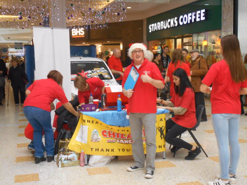 A group of people standing around a table.
