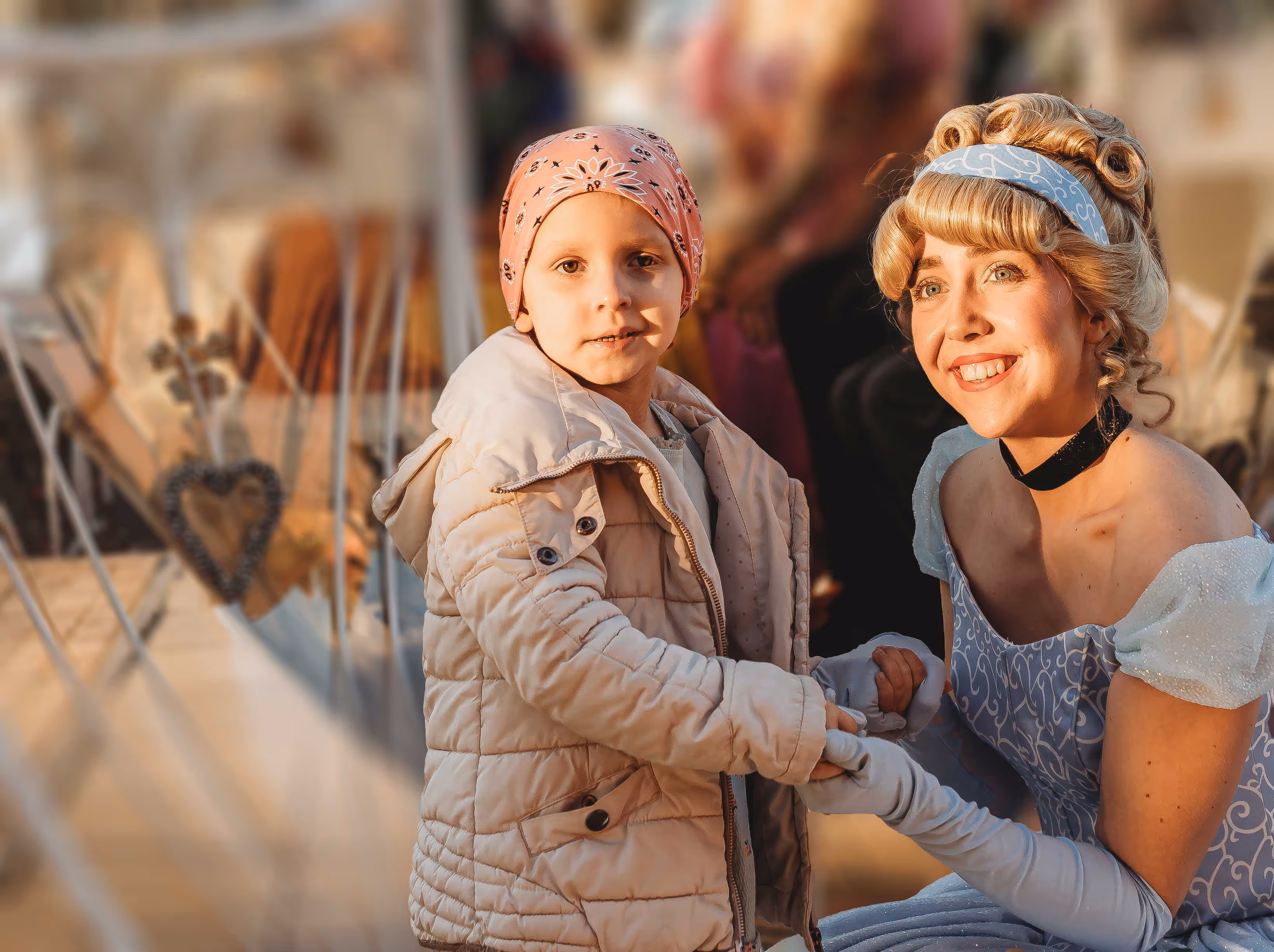 A woman sitting next to a little girl on a boat.