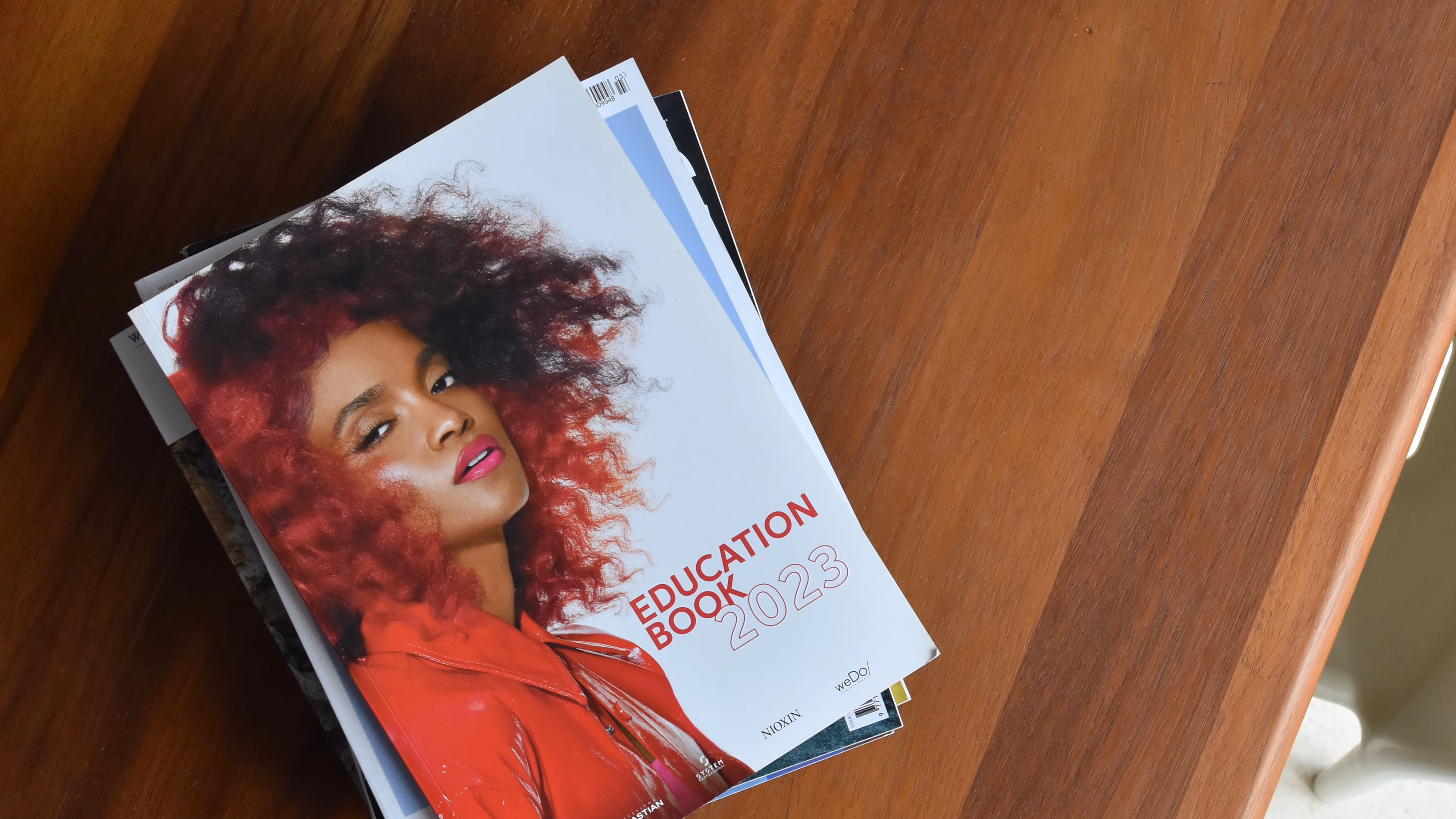 Wella Education book cover on dark wood table top