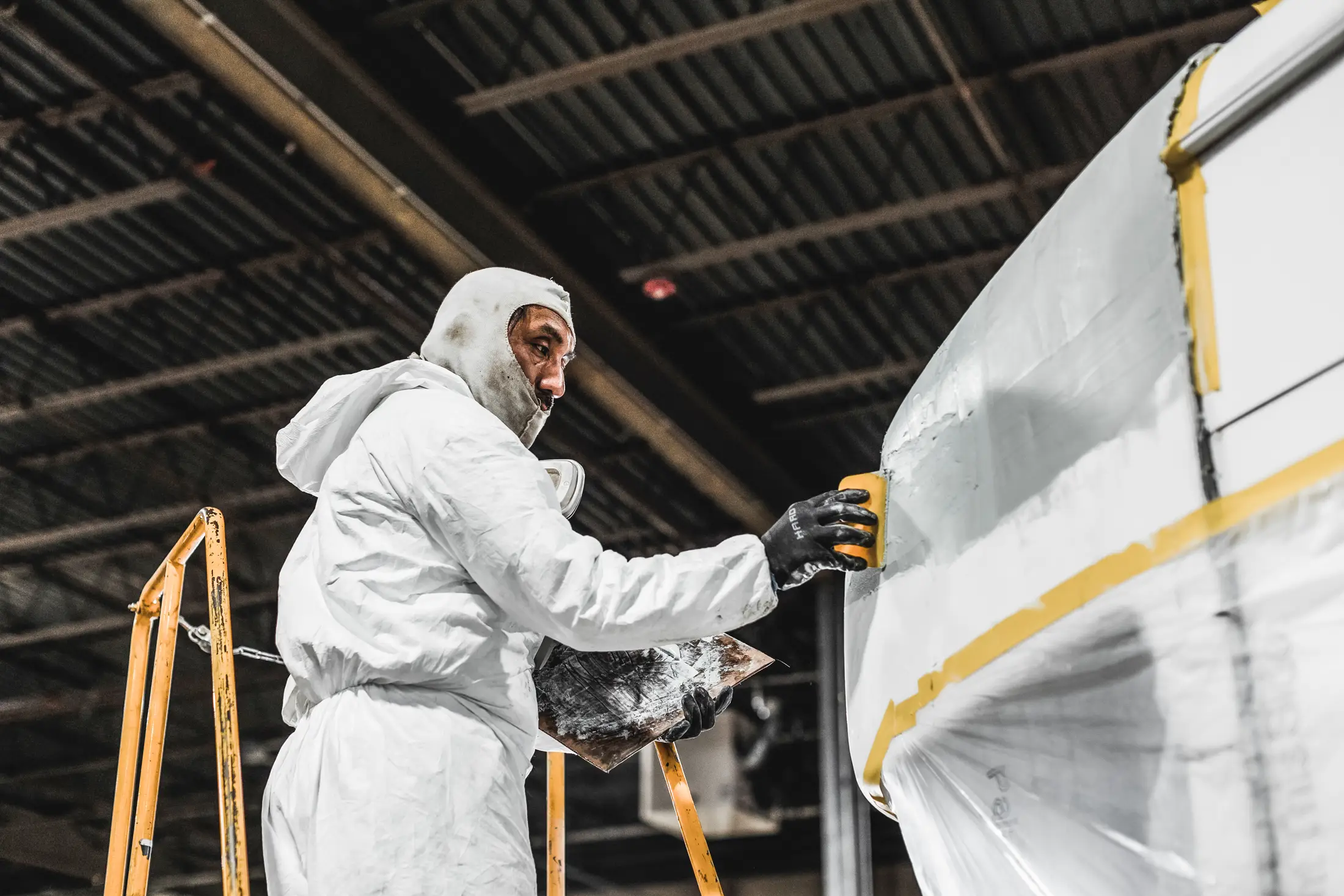 Diesel mechanic performing trailer collision repairs