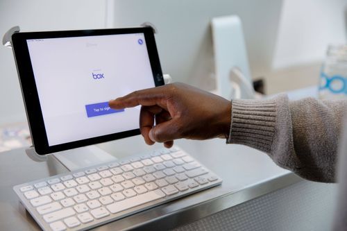Box front desk using Envoy visitor management system.
