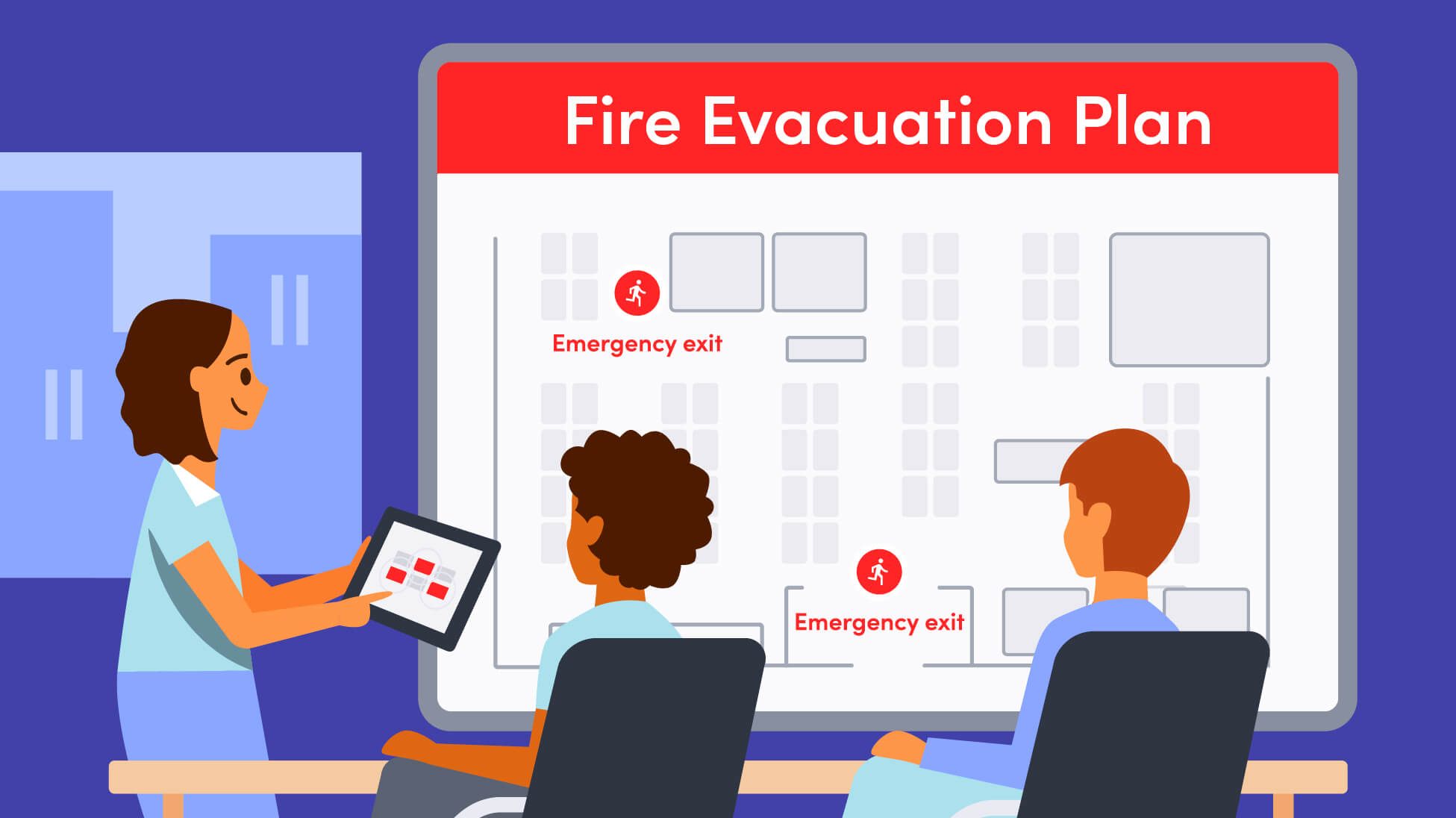 3 workplace leaders looking at a fire evacuation plan on a large screen