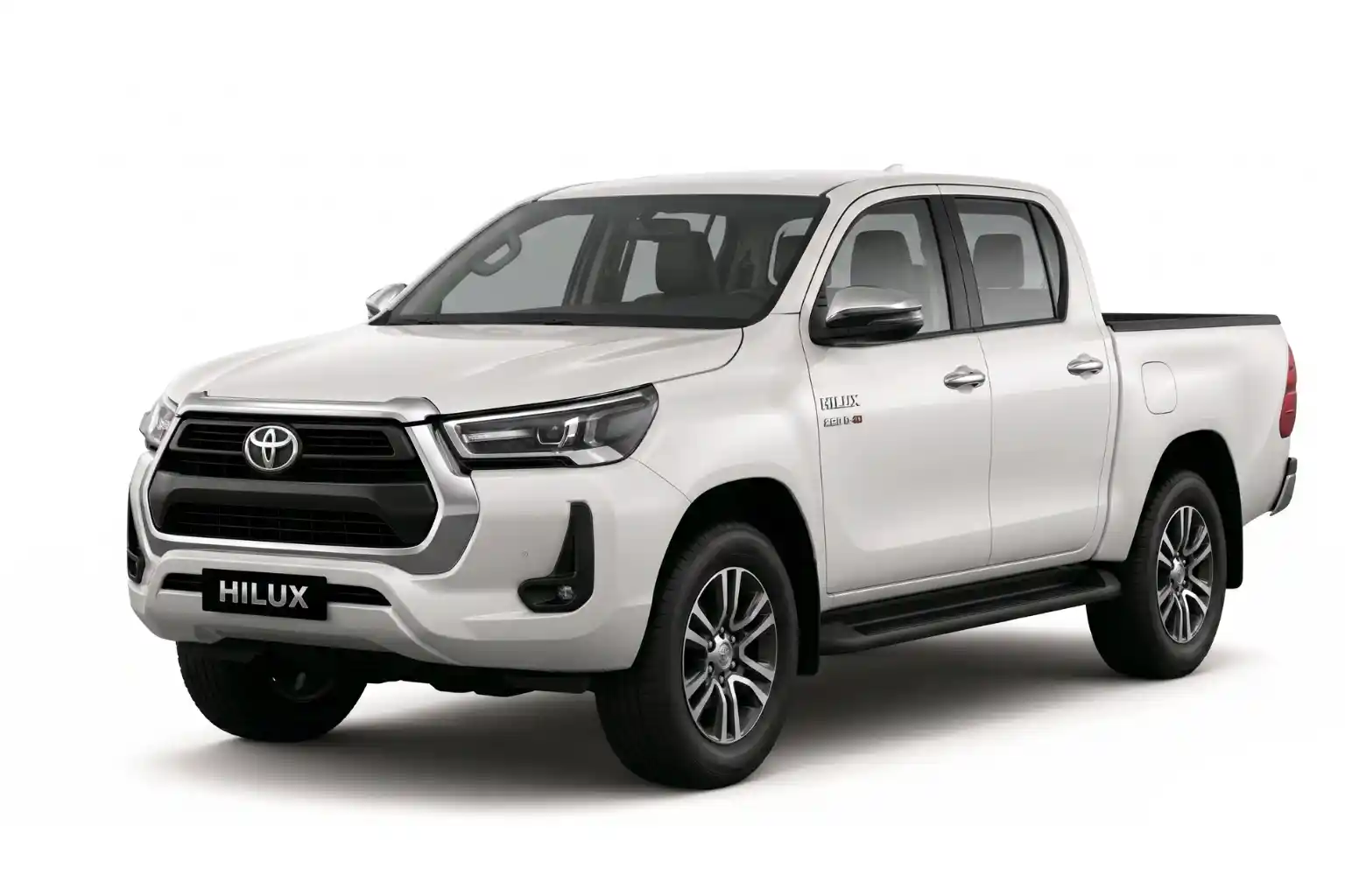 White Toyota Hilux double cab pickup truck against white background.