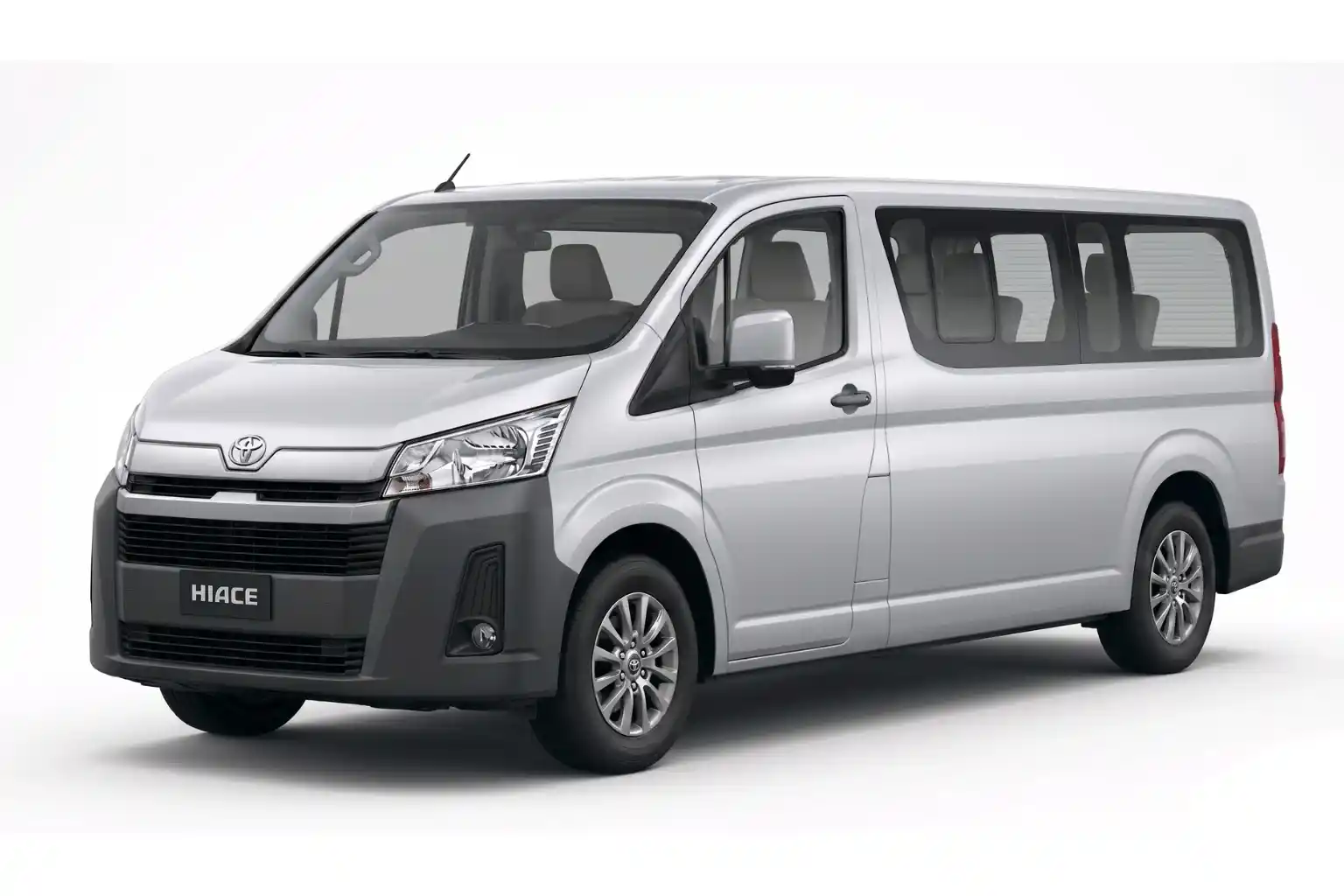 Silver Toyota Hiace passenger van angled left on white background.