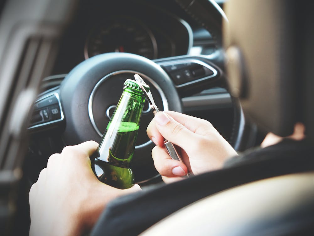 Free Person Opening Bottle on Car Stock Photo