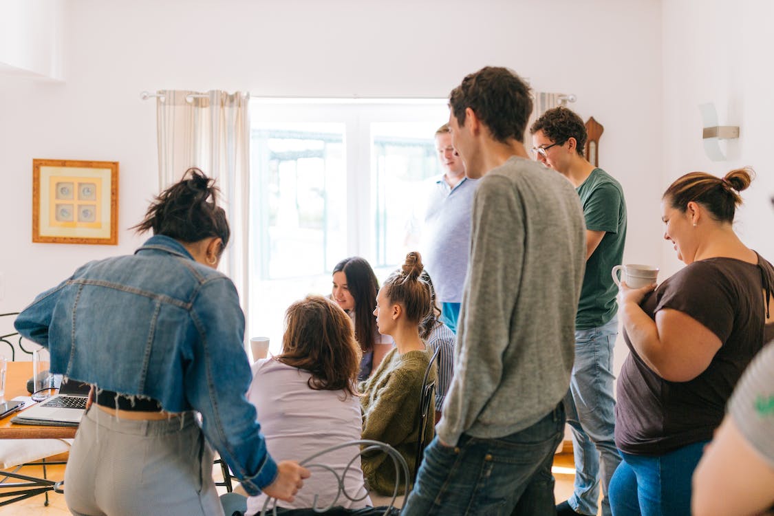 Free Five People Standing Near Four People Sitting Near Desk Stock Photo