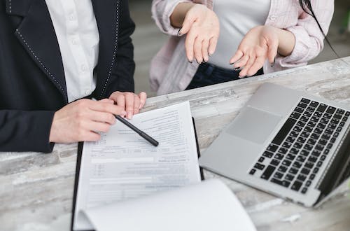 Free A Person Holding a Black Pen Stock Photo