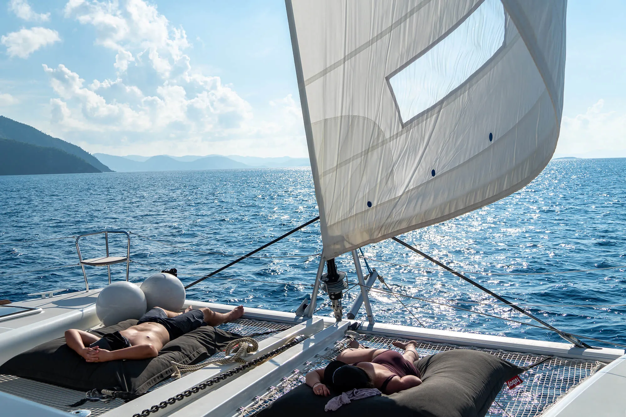 Friends sunbathing on a yacht