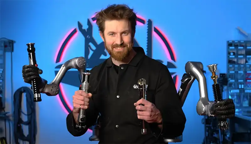 James holding 4 lightsabers - contact image for business