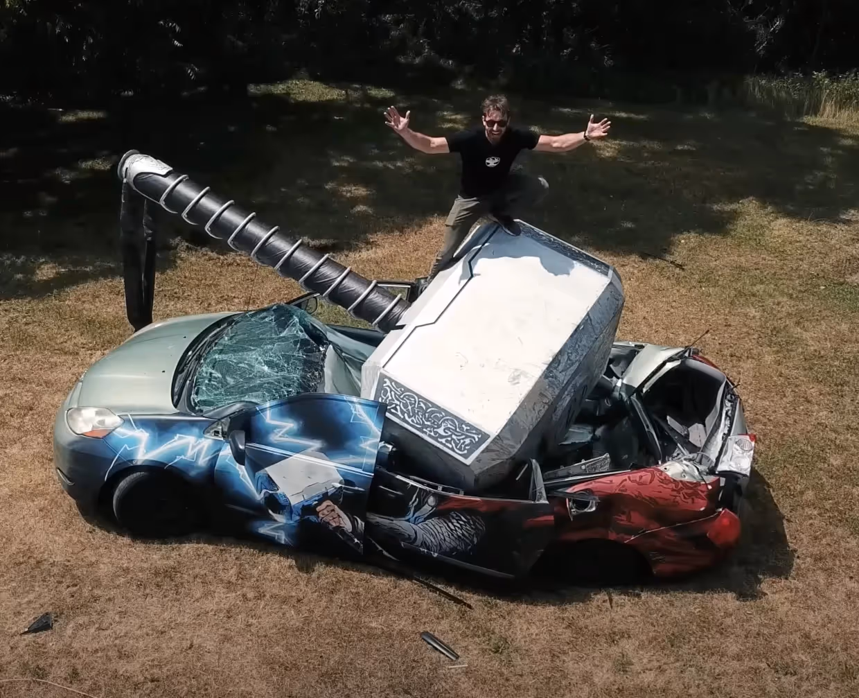 Giant Thor's hammer dropped on a car with James on top of the hammer