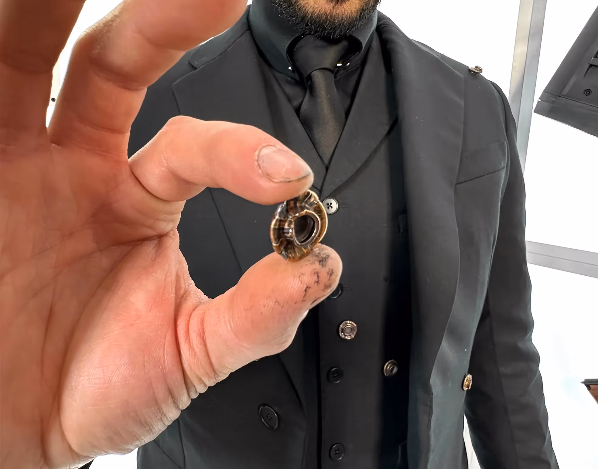 James Hacksmith wearing John Wick's bulletproof jacket, showing bullet