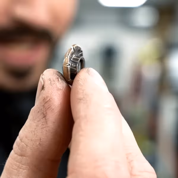 James Hacksmith wearing John Wick's bulletproof jacket, showing bullet closeup